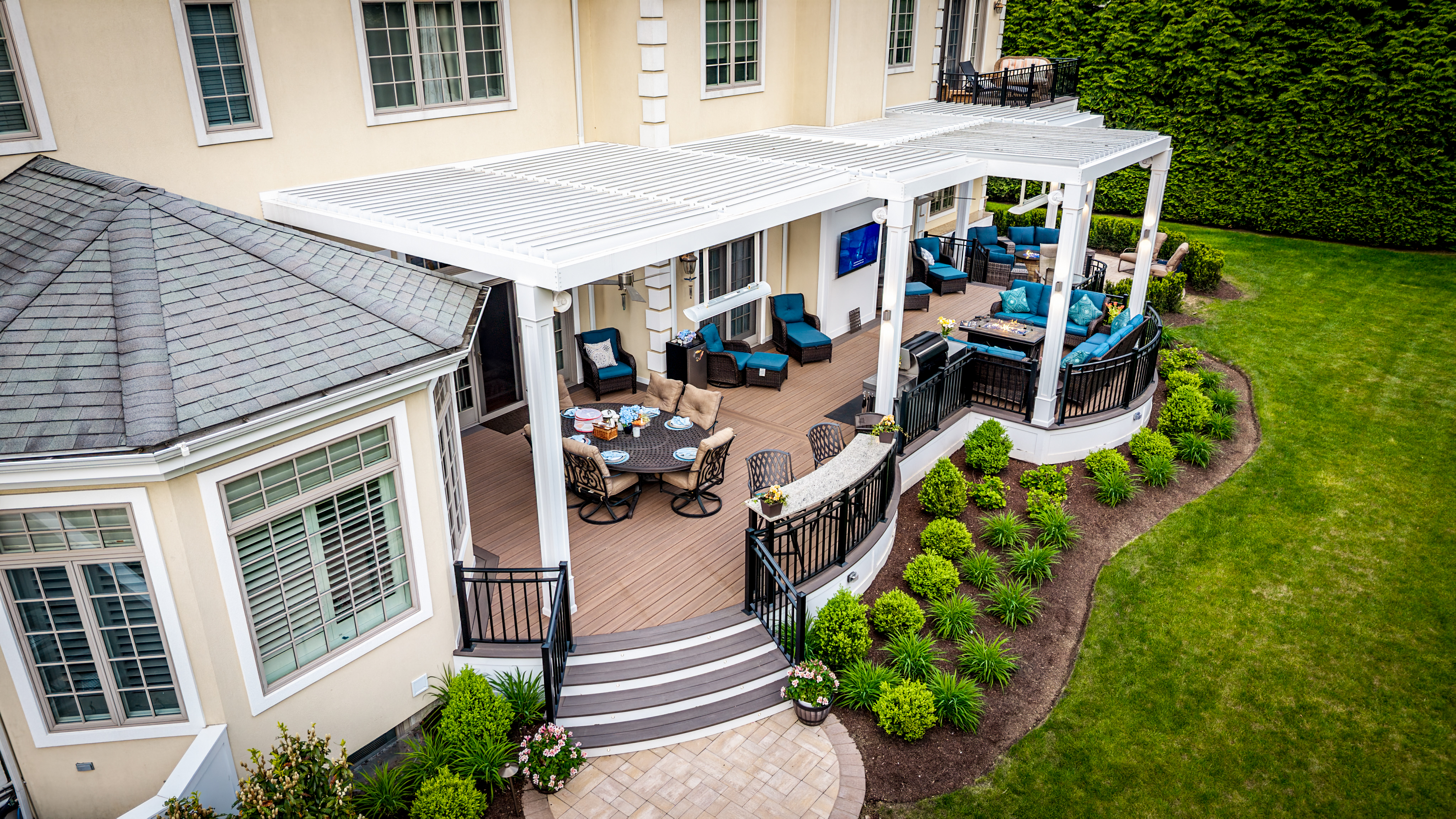 covered deck with louvered roof spanning multiple seating and dining areas for flexible outdoor living