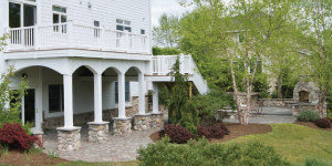 Arched stone columns create a two-story deck